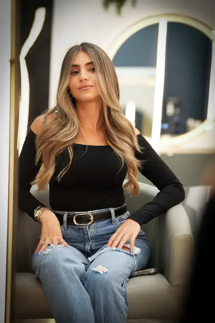 Lived-in blonde color with soft transitions and root melt on medium-length hair