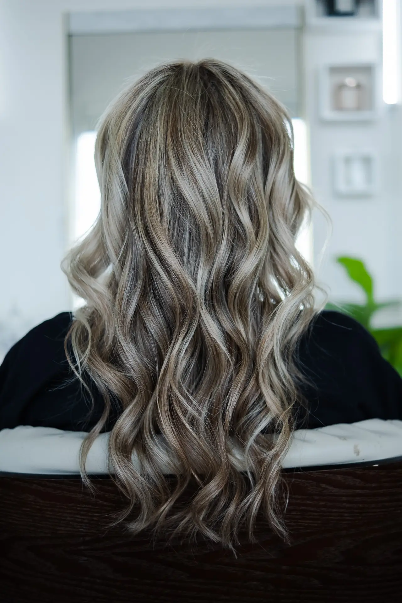 Wavy silver blonde balayage hairstyle at luxury salon in Miami