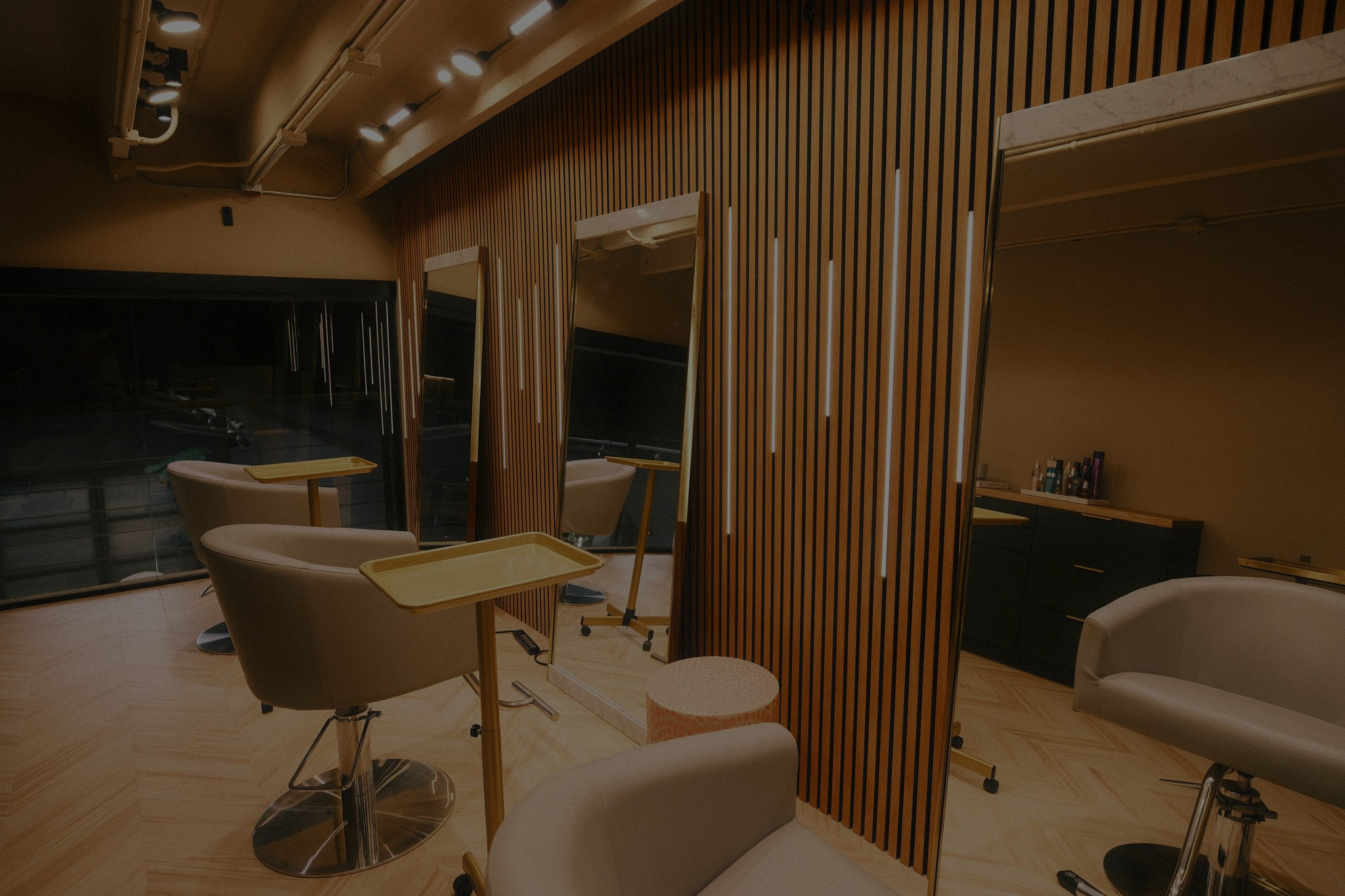Styling stations with wood slat walls at Arvel Hair salon in Little River, Miami