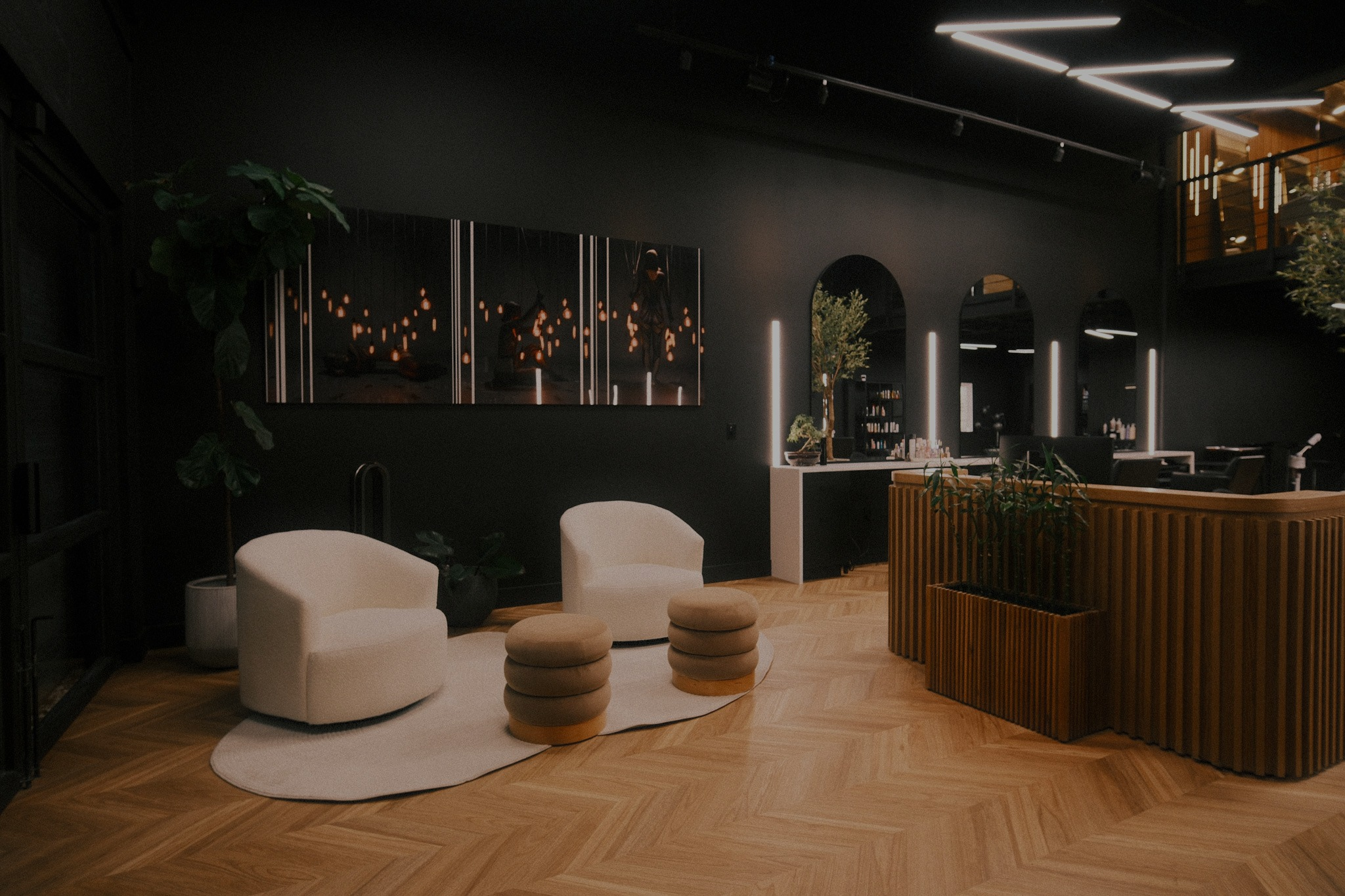Lounge seating and styling area at Arvel Hair salon
