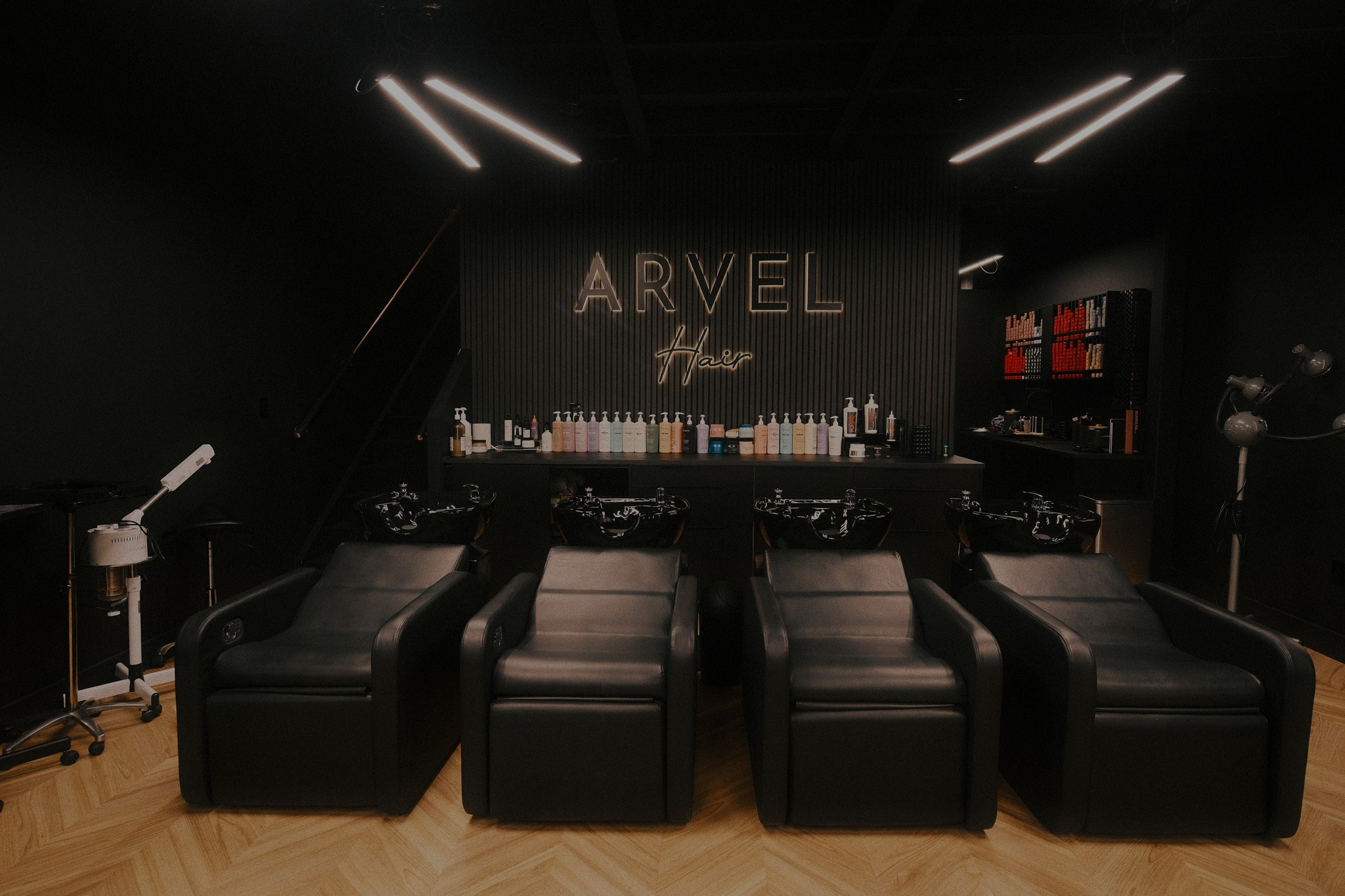 Shampoo stations below the Arvel Hair sign